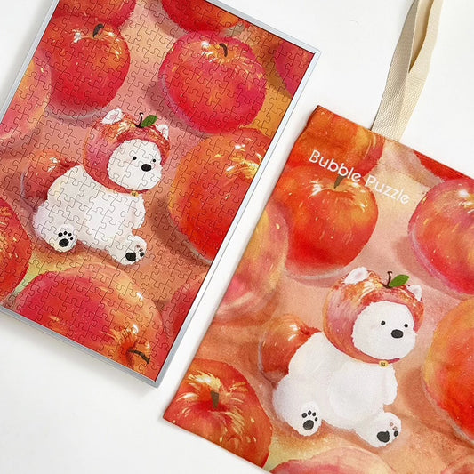 Jigsaw puzzle with a white bear in an apple costume and a tote bag with the same design.